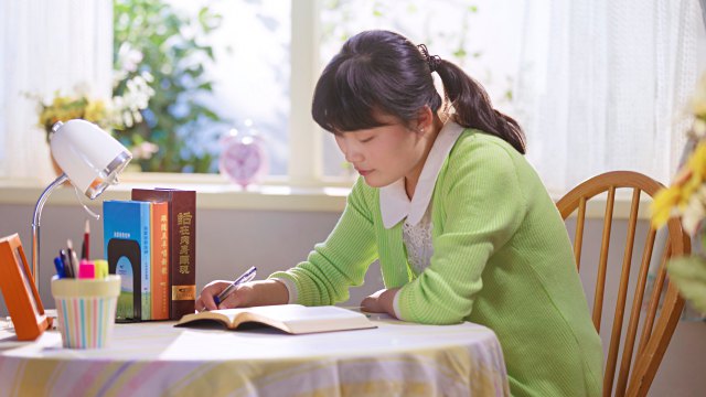 A little girl is reading the Word of God