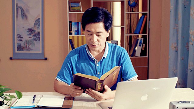 A Christian holding a book of Almighty God's Word