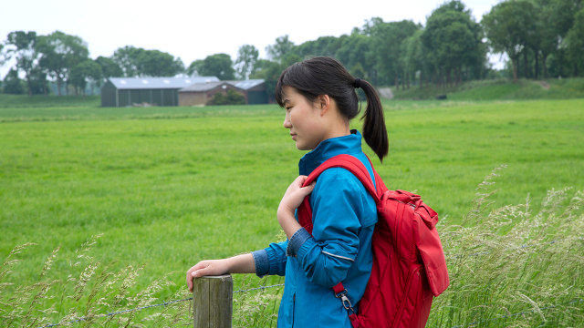 Carrying a school bag to go to school